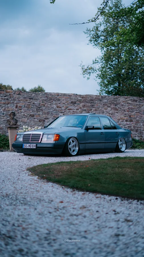 Tiefergelegter Mercedes-Benz vor einer Steinmauer